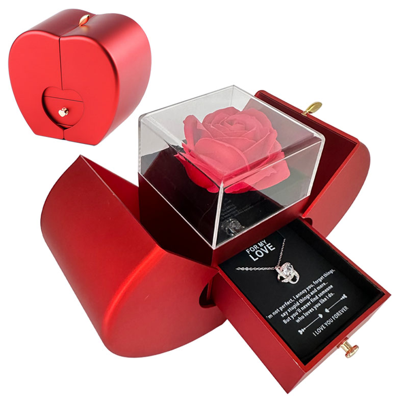 Red apple box opened: artificial red rose under a clear cube, drawer pulled out with a silver-tone necklace on a love message card; the closed apple in the corner